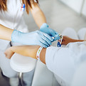 Medical professional taking blood sample for diagnostic testing